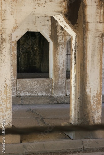 Old concrete arch supporting an urban structure.