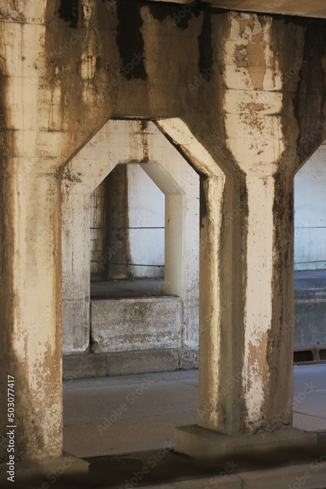 Fototapeta premium Old concrete arch supporting an urban structure.