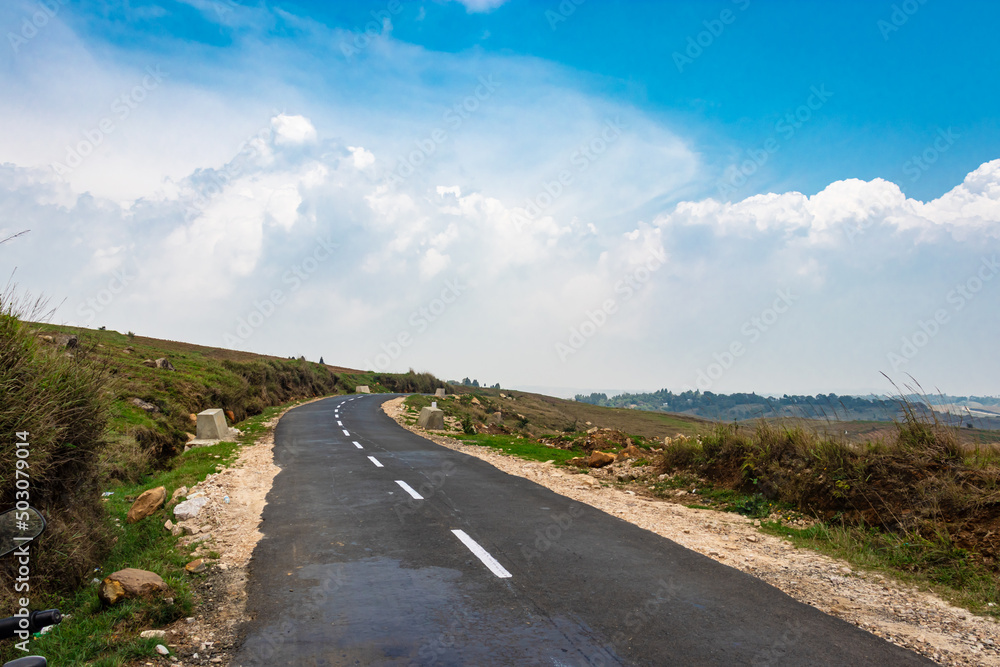 isolated tarmac road with bright blue sky at morning from flat angle isolated tarmac road with bright blue sky at morning from flat angle