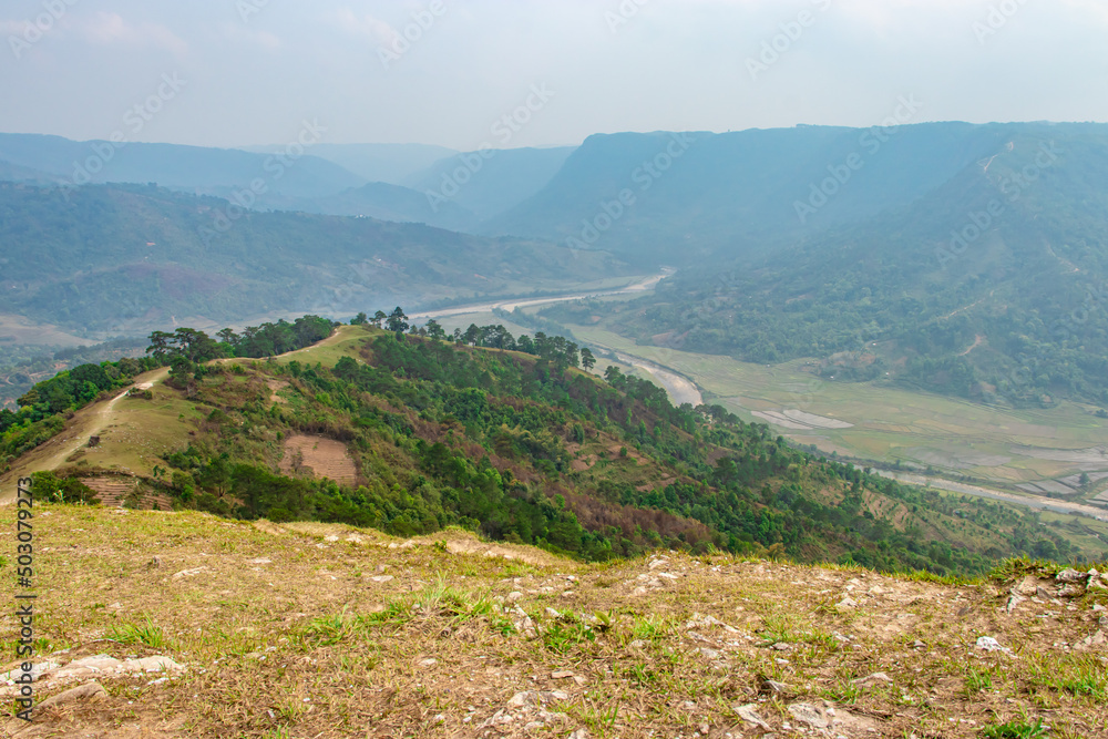 agriculture farming Fields with river flowing and surrendered by mountain at morning from top angle agriculture farming Fields with river flowing and surrendered by mountain at morning from top angle