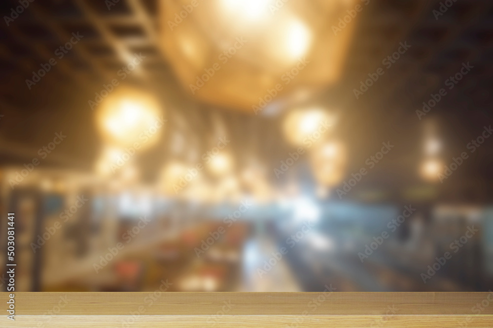 Empty top of wood for product display. Blur restaurant and cafe background. Retro Cafe background.