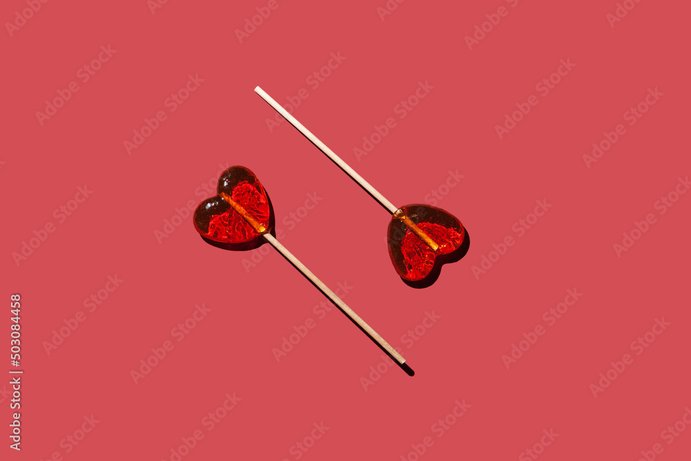 two lollipops hearts on a red background pattern two lollipops hearts on a red background pattern