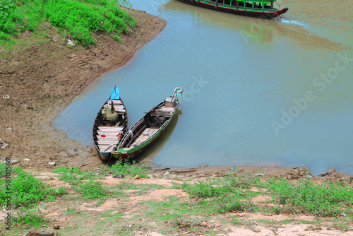 Old fishing boat on the side of the river in kaptai lake, Rangamati, Bangladesh photo