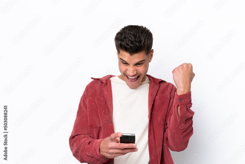 Young caucasian man isolated on white background surprised and sending a message Young caucasian man isolated on white background surprised and sending a message