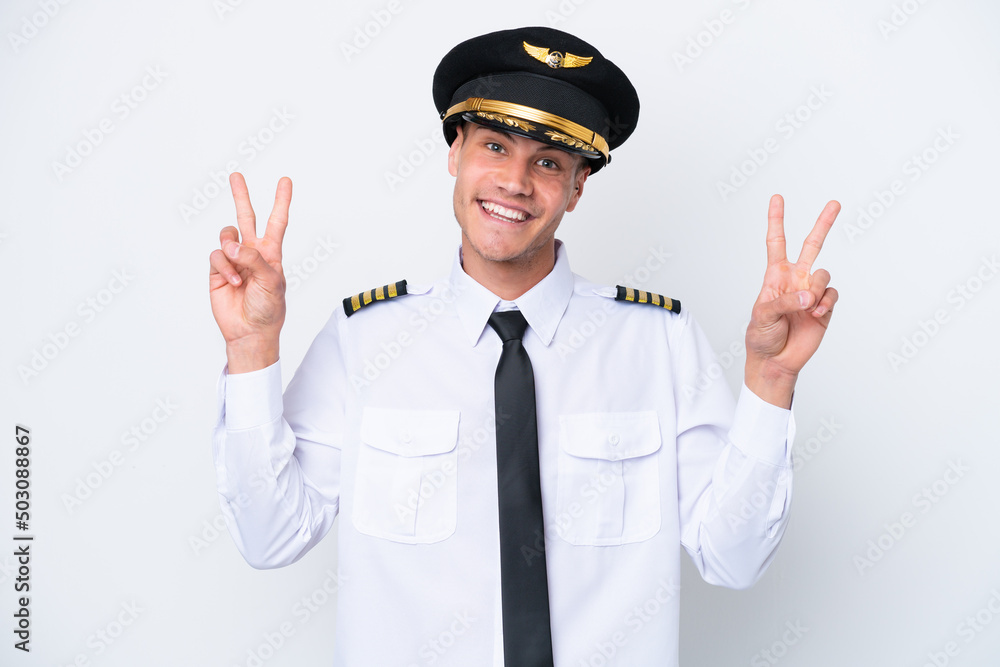 Airplane caucasian pilot isolated on white background showing victory sign with both hands Airplane caucasian pilot isolated on white background showing victory sign with both hands