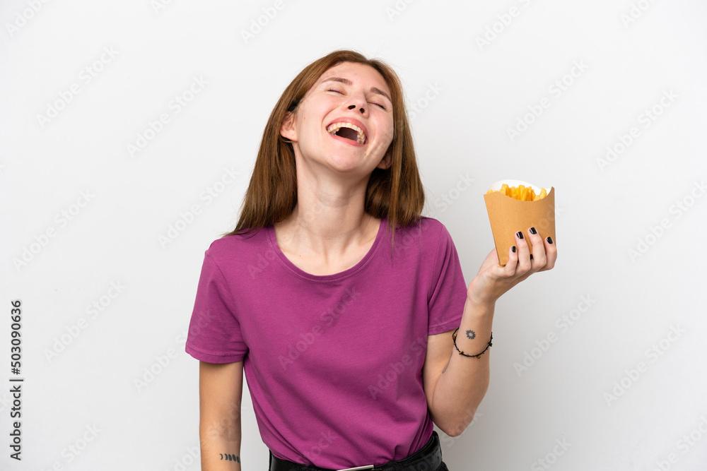 Young English woman holding fried chips isolated on white background laughing Young English woman holding fried chips isolated on white background laughing