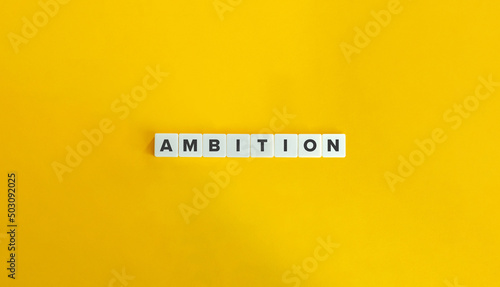 Ambition Word on Letter Tiles on Yellow Background. Minimal Aesthetics.