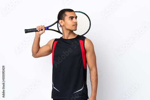 African American man over isolated white background playing tennis