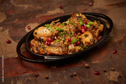 Tasty fried chicken spiced with pomegranate and greens