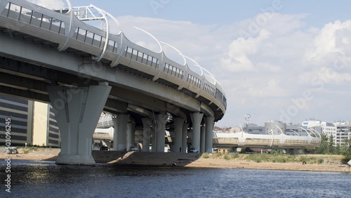 Cable-stayed bridge across the Neva River. Sandy shore.