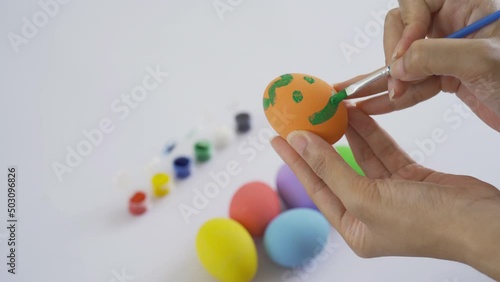 Wallpaper Mural Hand painting colorful easter eggs on white background. Food decoration on holiday. People lifestyle. Torontodigital.ca