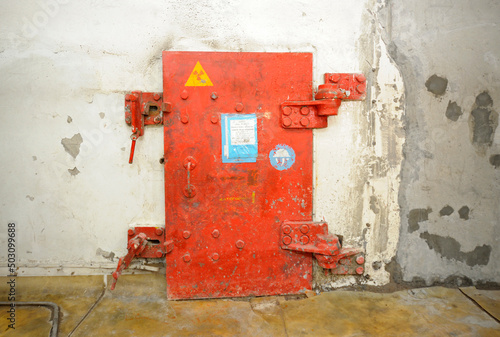 Metal protective door to the block with contaminated radioactive equipment placed after disaster in 1986. Chernobyl Nuclear Power Plant, Ukraine photo