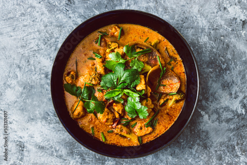 vegan broccoli tofu and onion curry with fresh coriander and herbs as topping, healthy plant-based food recipes