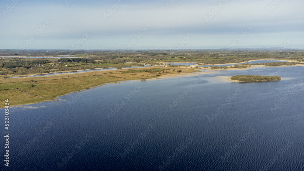 Aerial view of a forest lake. Aerial view of lake and forest boarder on a sunny summer day. Drone photography. Aerial view of a forest lake. Aerial view of lake and forest boarder on a sunny summer day. Drone photography.