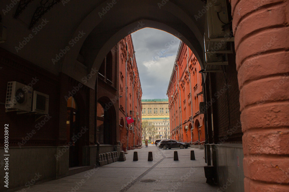 Small alley with brick buildings and an archway