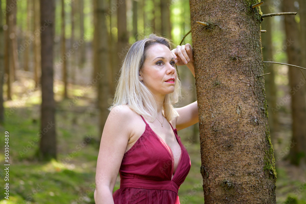 Thoughtful woman in sensuous dress posing at forest. Thoughtful woman in sensuous dress posing at forest.