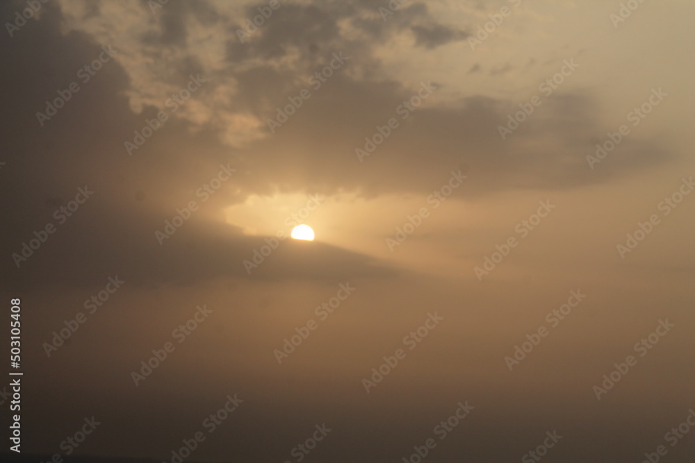 The view of the morning sun on the horizon among the clouds with a very beautiful view The view of the morning sun on the horizon among the clouds with a very beautiful view