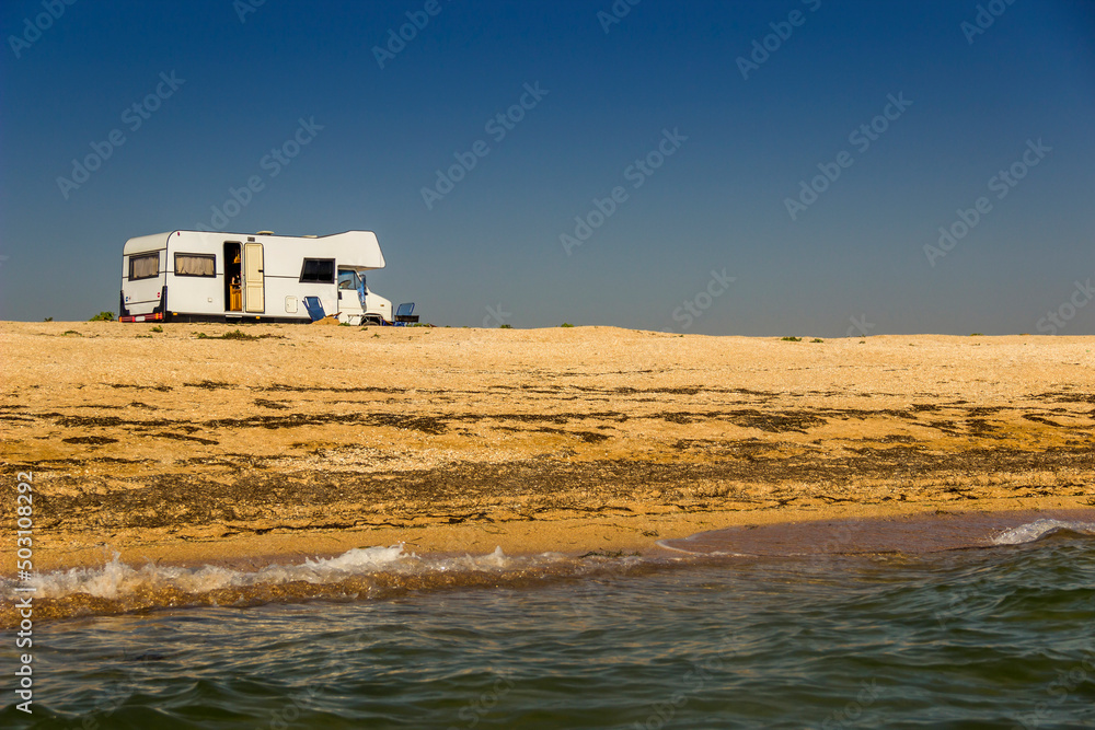 trailer-house on wheels on the Azov sea beach, Ukraine