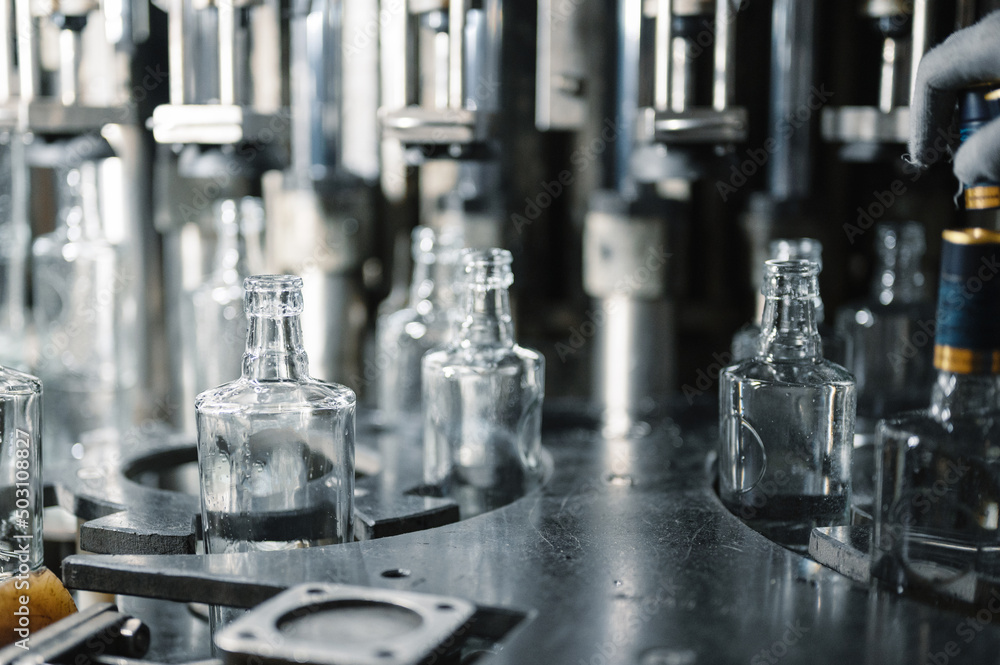Filling glass bottles with liquid. Filling glass bottles with liquid.