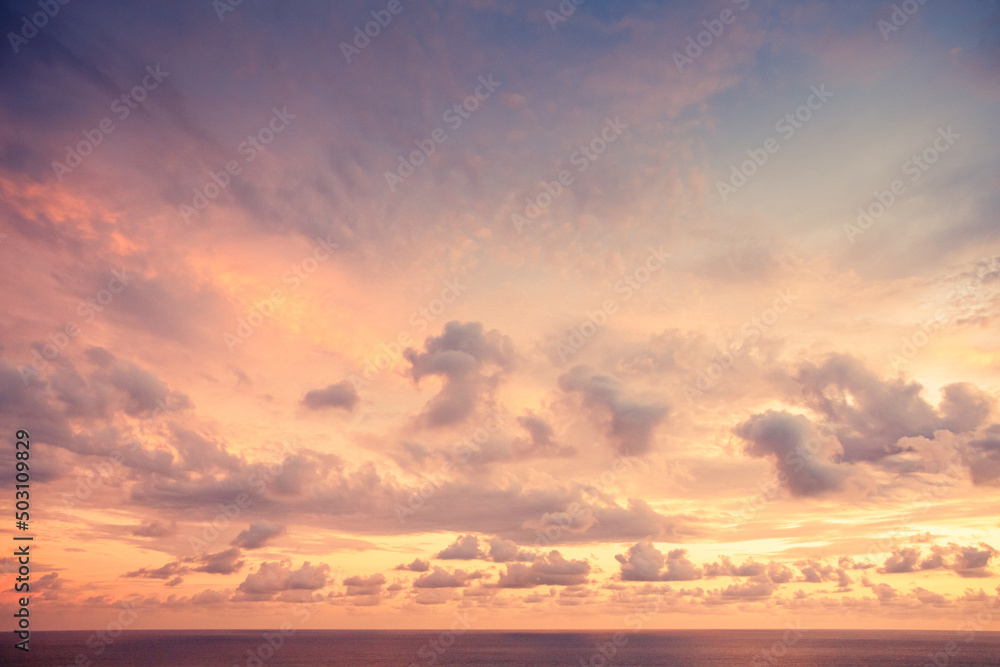 Purple sunset with calm ocean and clouds
