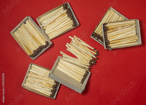 Matchsticks on a red background. Safe handling of fire. Fire dangers. Lots of matches. still life. Matchsticks boxes