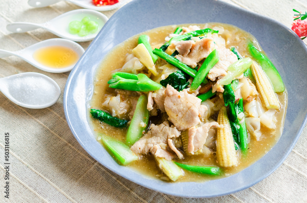 Homemade Stir-Fried Noodles with Gravy Sauce on table. (Thai food) Homemade Stir-Fried Noodles with Gravy Sauce on table. (Thai food)
