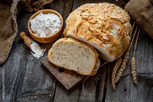 Bild auf Leinwand Fresh homemade bread on a wooden table