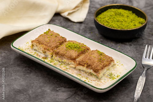 Cold baklava. Baklava with milk on a dark background. Mediterranean cuisine delicacies. Close-up. Local name soguk baklava photo