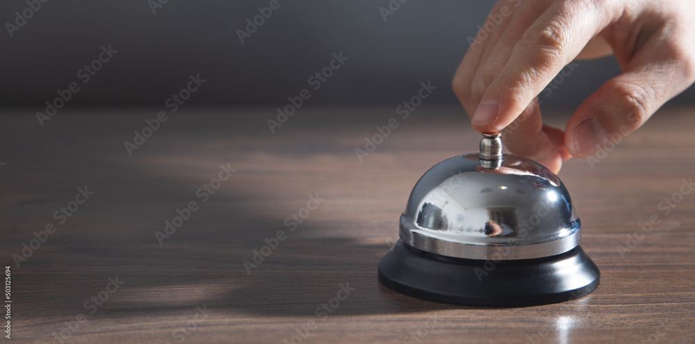 Male hand ringing in service bell. Male hand ringing in service bell.