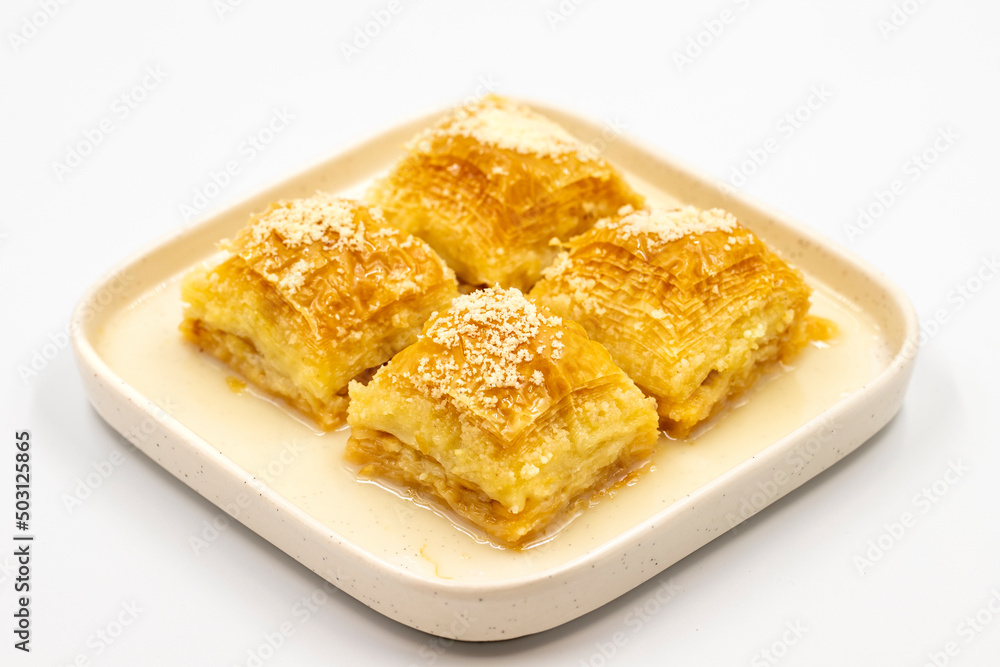 Milk baklava. Baklava with hazelnuts isolated on a white background. Mediterranean cuisine delicacies. Close-up. local name sutlu nuriye baklava Milk baklava. Baklava with hazelnuts isolated on a white background. Mediterranean cuisine delicacies. Close-up. local name sutlu nuriye baklava