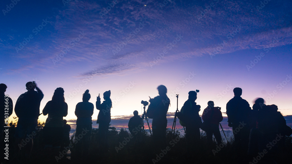 Silhouette group of travel people enjoying sunset on top of mountain Silhouette group of travel people enjoying sunset on top of mountain