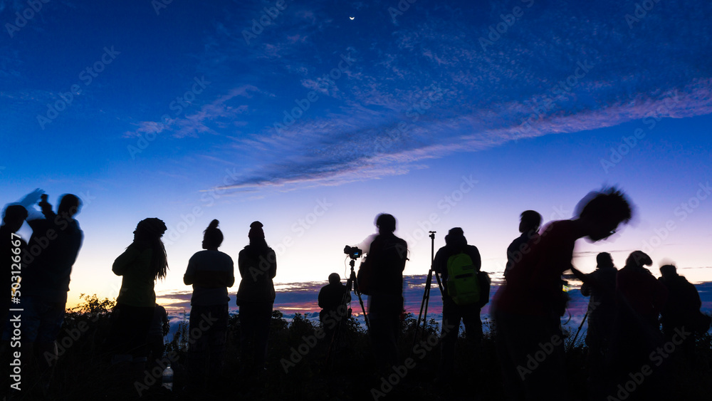 Silhouette group of travel people enjoying sunset on top of mountain Silhouette group of travel people enjoying sunset on top of mountain