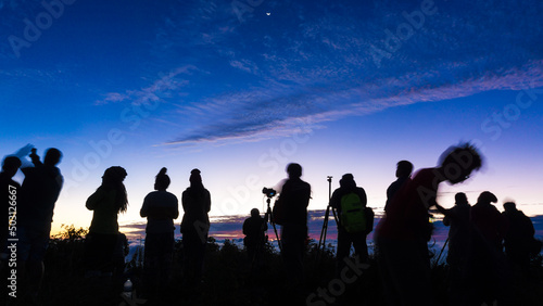 Silhouette group of travel people enjoying sunset on top of mountain