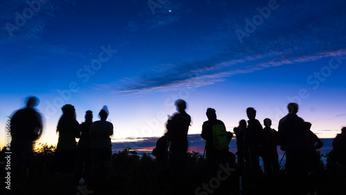Silhouette group of travel people enjoying sunset on top of mountain
