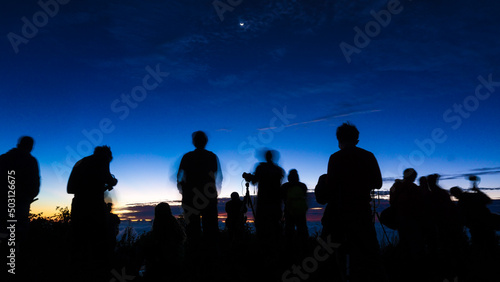 Silhouette group of travel people enjoying sunset on top of mountain