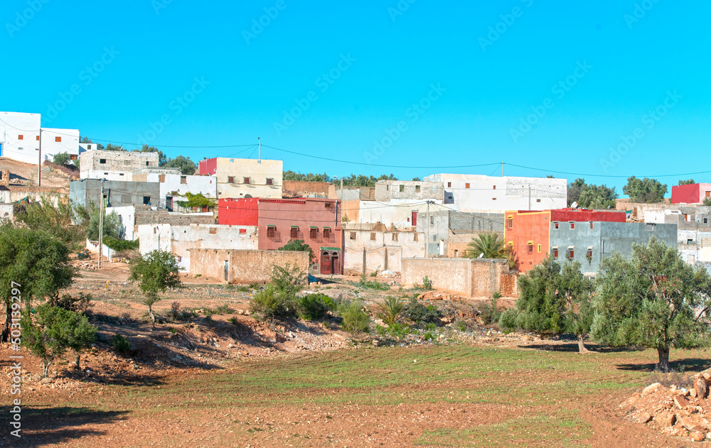Traditional small Moroccan village with colorful houses in desert