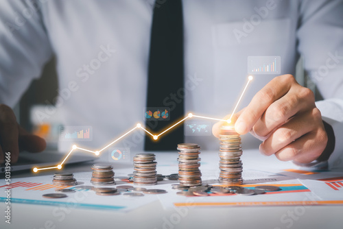 Photos Business man putting coins Business growth and investment chart, strategic planning to increase profits from doing business, long-term investment planning