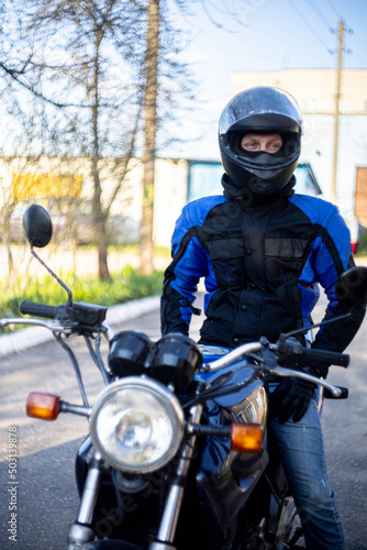 male motorcyclist in blue gear and helmet.