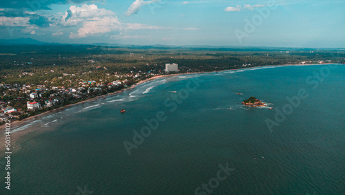 Tropical coast and ocean, drone shot, beautiful beach and water, tourist paradise.