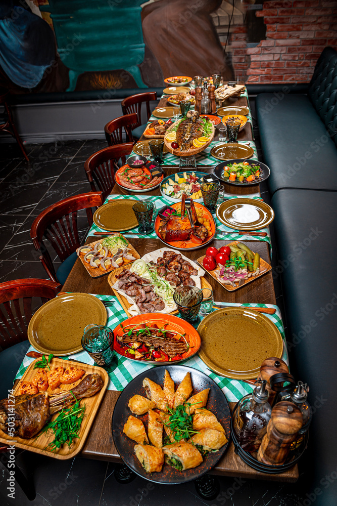 Restaurant table, many different dishes.