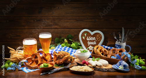 Festive served table with Bavarian specialities. Oktoberfest menu