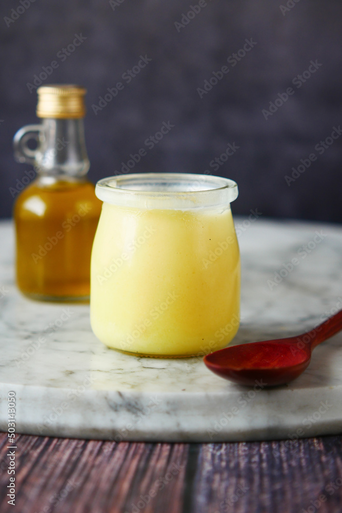 homemade ghee in container on a table , homemade ghee in container on a table ,