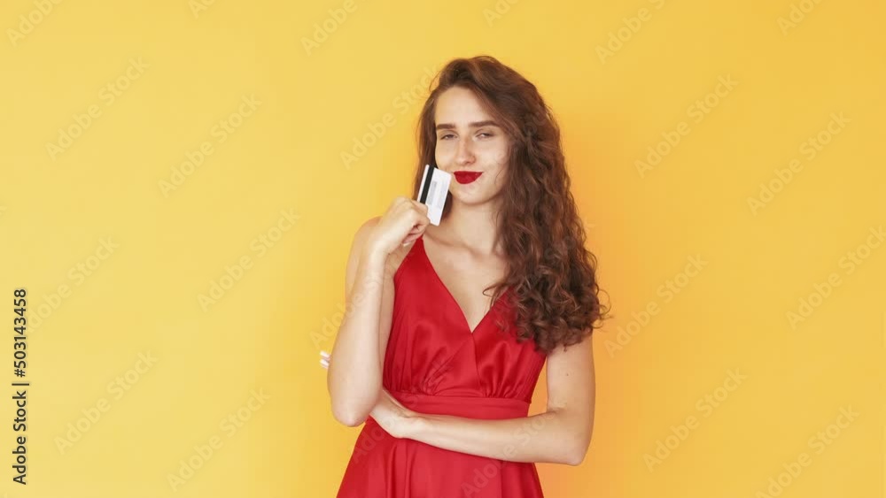 Online payment. Meme woman. Satisfied expression. Pretty happy lady holding credit card looking curious isolated yellow looped video. Online payment. Meme woman. Satisfied expression. Pretty happy lady holding credit card looking curious isolated yellow looped video.