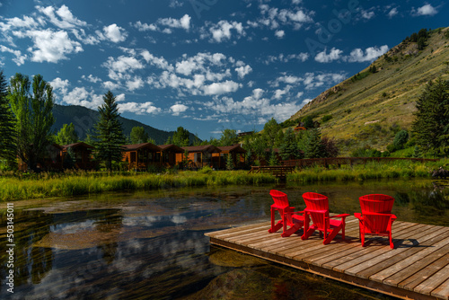 Outdoor chairs by a lake with a mountain as a backdrop in Jackson, Wyoming, USA.