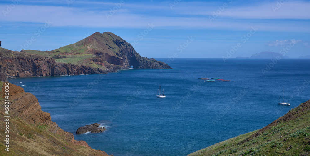 Ponta de San Lorenzo, the easternmost point of the Madeira Island and a nature reserve. The island in the North Atlantic Ocean. Yachts at the foreground and the Desertas Islands at the background.