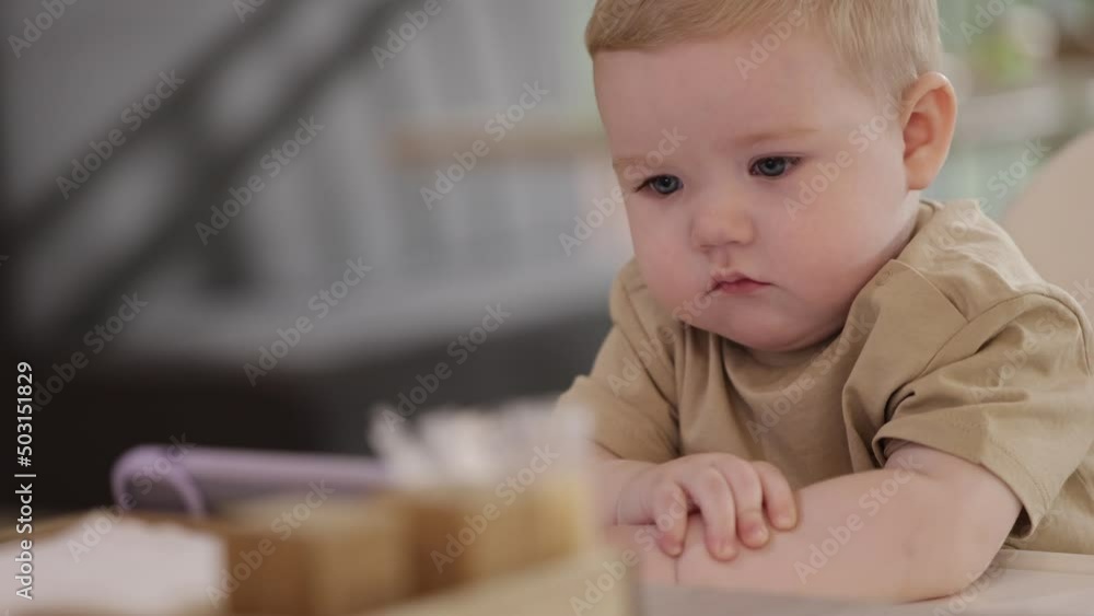 kid sitting in a cafe seriously watching cartoons kid sitting in a cafe seriously watching cartoons