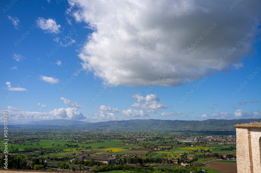 Panoramic wide view of the countryside surrounding the medieval village of Assisi, in springtime (Umbria, central Italy). It's world famous as the city of St. Francis.