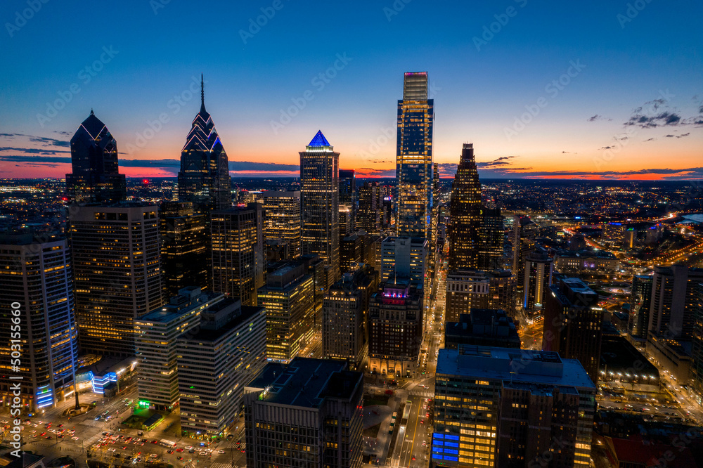 Fototapeta premium Aerial Drone View of Philadelphia Skyline at Sunset with Glowing City Lights