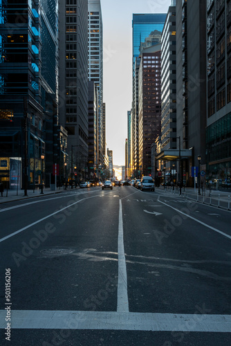 Cars Driving at Sunset by Buildings in Philadelphia