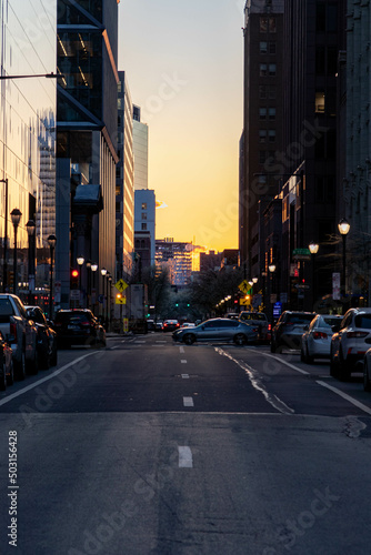 Cars Driving at Sunset by Buildings in Philadelphia